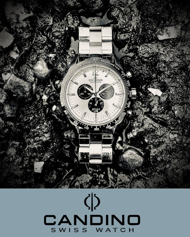Candino ur med stålkasse og chronograph, sølvfarvet, forside, ligger på våd, mørk sten.